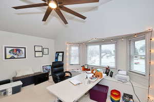 Office space featuring ceiling fan and vaulted ceiling