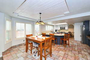 Dining space with arched walkways and baseboards