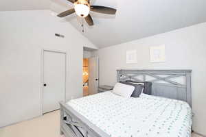 Bedroom featuring a ceiling fan, light colored carpet, vaulted ceiling, and visible vents