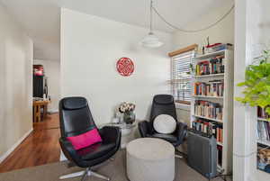 Living area with dark wood-type flooring