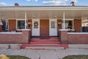 View of exterior entry with covered porch