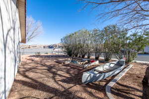 View of yard featuring a vegetable garden, fence, and a mountain view