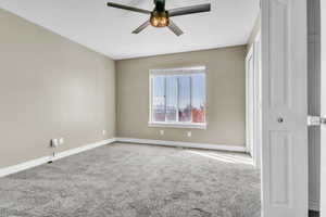 Unfurnished bedroom featuring ceiling fan, baseboards, and carpet flooring