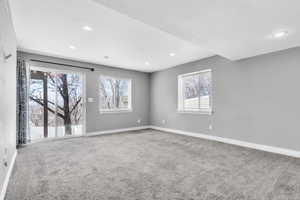 Unfurnished room featuring a wealth of natural light, carpet flooring, baseboards, and recessed lighting