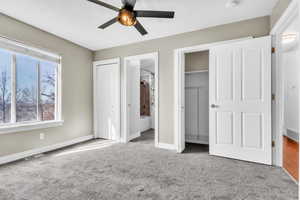 Unfurnished bedroom featuring ensuite bath, carpet, visible vents, and baseboards