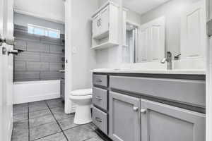 Bathroom featuring vanity, toilet, and tile patterned floors