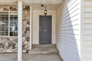 View of exterior entry with stone siding