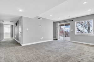 Carpeted empty room featuring recessed lighting, visible vents, and baseboards