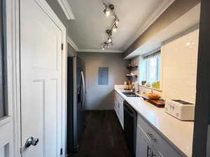 Kitchen featuring stainless steel refrigerator with ice dispenser, ornamental molding, a sink, a textured ceiling, and dishwasher