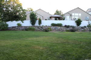 View of back yard with raised gardening area.