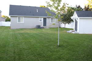 Back of house featuring storage shed.