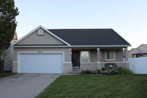 View of front facade with a 2 car garage and a covered porch