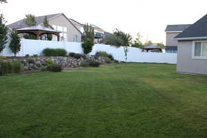 View of yard featuring raised rocked garden area in Backyard