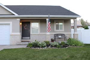 View of front of home featuring porch and landscaping.