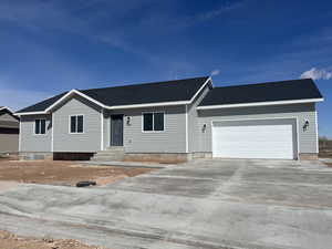 Ranch-style home with concrete driveway, a garage, roof with shingles, and entry steps
