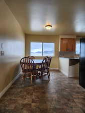 Dining room with stone finish floor and baseboards