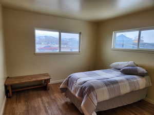 Bedroom featuring wood finished floors and baseboards