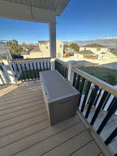 Wooden deck featuring a residential view and a mountain view