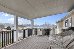 Covered Trex deck with a mountain and lake view