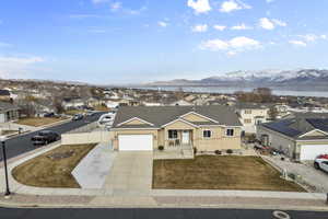 View of front facade featuring a residential view, a mountain view, fence, and stucco siding