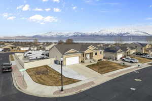 View of front of property featuring a mountain view, an attached garage, fence, and a residential view