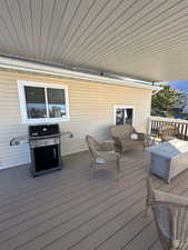 Wooden terrace featuring area for grilling