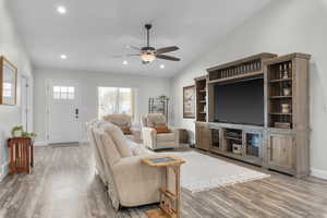 Living area with lofted ceiling, ceiling fan,