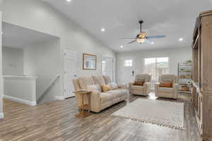 Living area with recessed lighting, vaults LVP finished floors