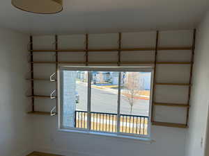 Empty room featuring visible vents, baseboards, and wood finished floors