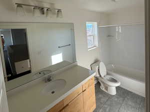 Full bathroom with toilet, vanity, visible vents, and shower / bathtub combination