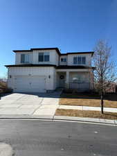 View of front of home featuring board and batten siding, concrete driveway, and an attached garage