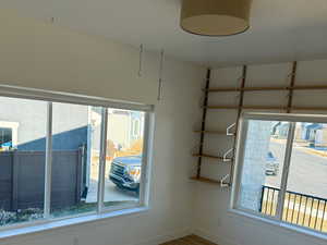 Unfurnished room featuring baseboards, visible vents, and wood finished floors