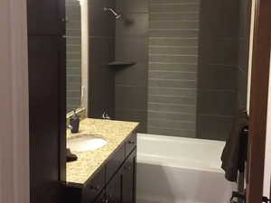Bathroom with shower / tub combination and vanity