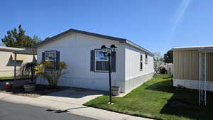 View of side of property with a yard