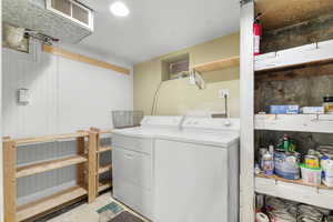 Laundry area with laundry area, visible vents, and washer and clothes dryer