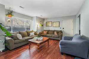 Living area featuring wood finished floors and visible vents