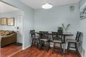 Dining space with wood finished floors and baseboards