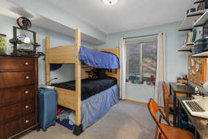 Bedroom featuring carpet flooring and baseboards