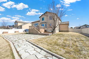 Back of property with a patio area, a fenced backyard, a deck, and stucco siding