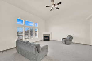 Living area with carpet, a fireplace, visible vents, and baseboards