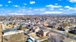 Birds eye view of property featuring a mountain view and a residential view