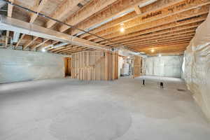 Unfinished basement featuring gas water heater