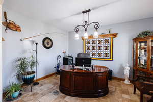 Home office with stone tile flooring and baseboards