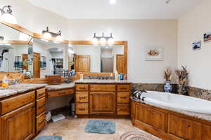 Bathroom with walk in shower, tile patterned flooring, a garden tub, and vanity