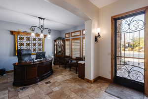 Entryway with baseboards and stone tile flooring