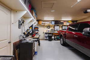 Garage with a garage door opener and a workshop area