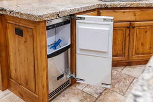 Interior details with wine cooler and brown cabinetry