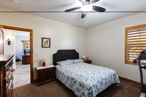 Bedroom with carpet floors, a ceiling fan, visible vents, and baseboards