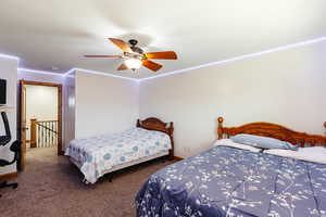 Carpeted bedroom with ceiling fan