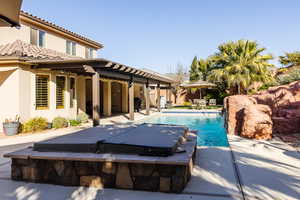 Pool with a patio area and fence